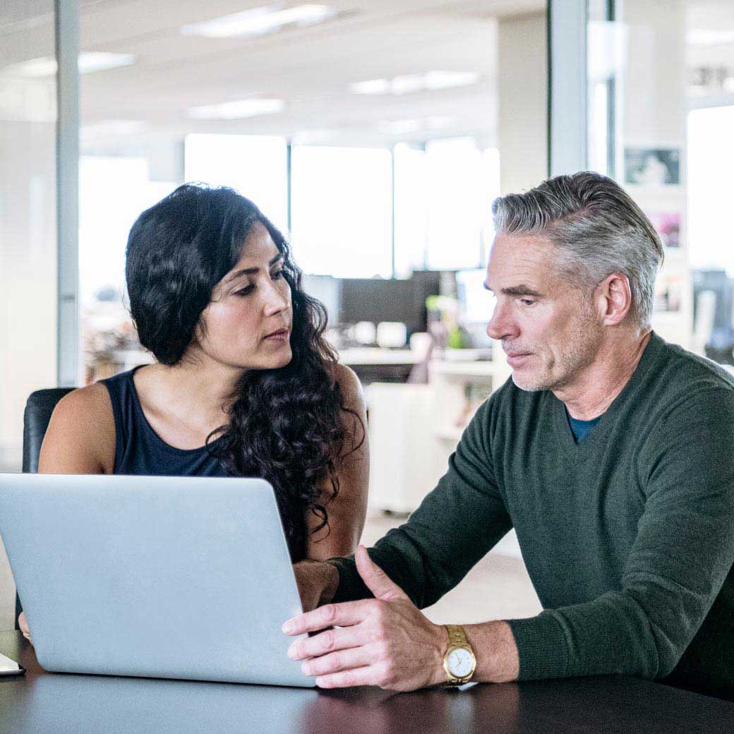 Business colleagues discuss web app security solutions | Qualys